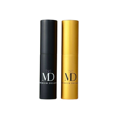 Two premium decant spray bottles from MD Decants, one in matte black and one in metallic gold, standing side-by-side on a plain white background.